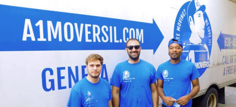 A1 Movers crew standing beside an A1 moving truck in Geneva, Illinois